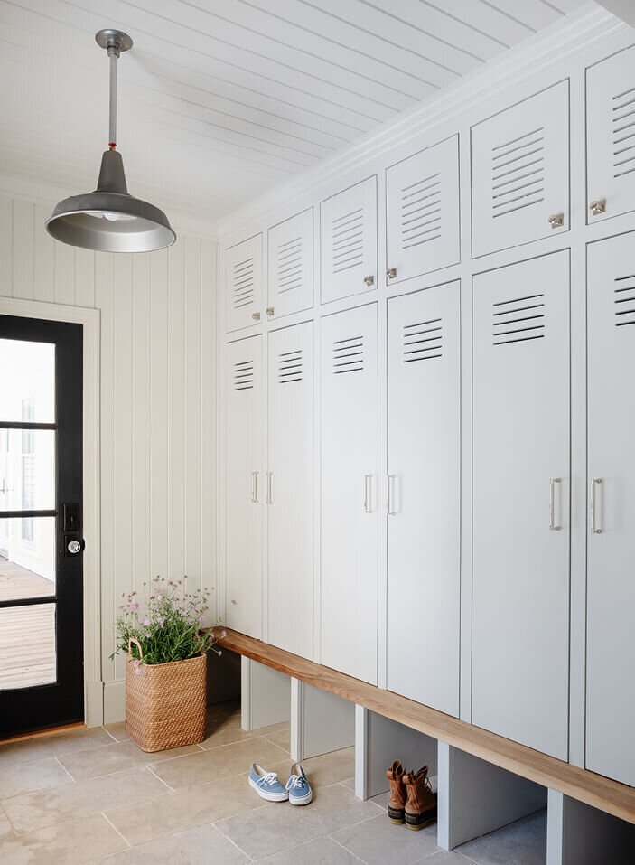 Light grey custom mudroom built-ins at a historic Hingham home renovation, designed by interior design firms in Hingham, Massachusetts, blending functionality with style.