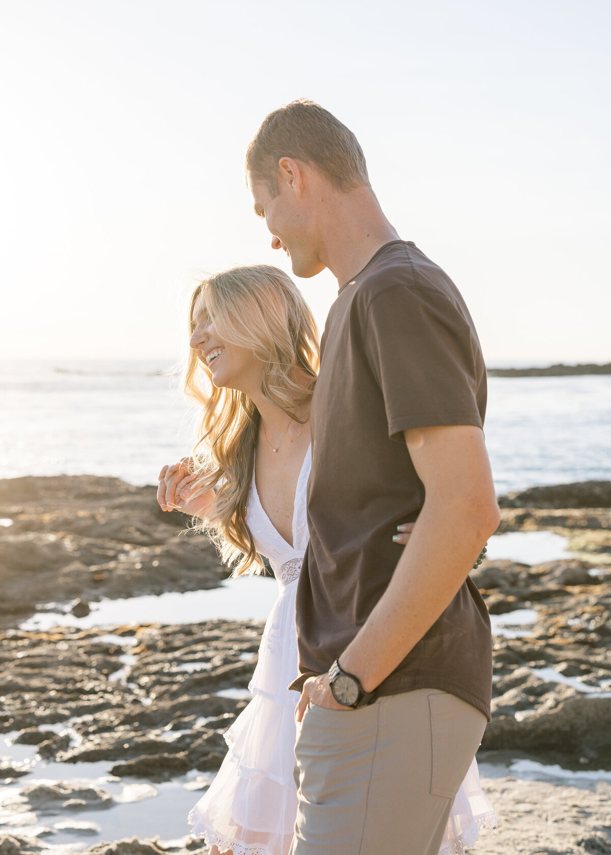 candid and fun engagement photo on the beach
