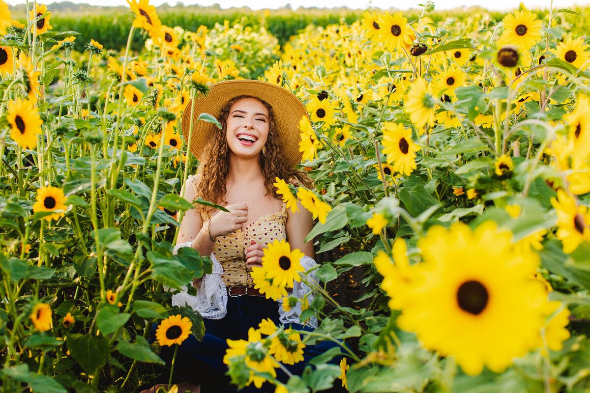 New-Cumberland-senior-photos-summer-sunflower-field-laughter-curly-hair