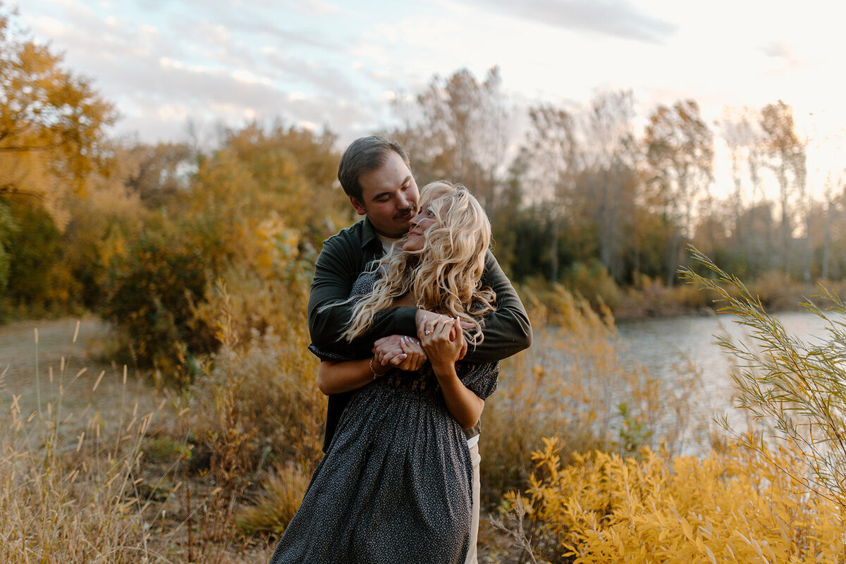 a couple hugging in the fall trees