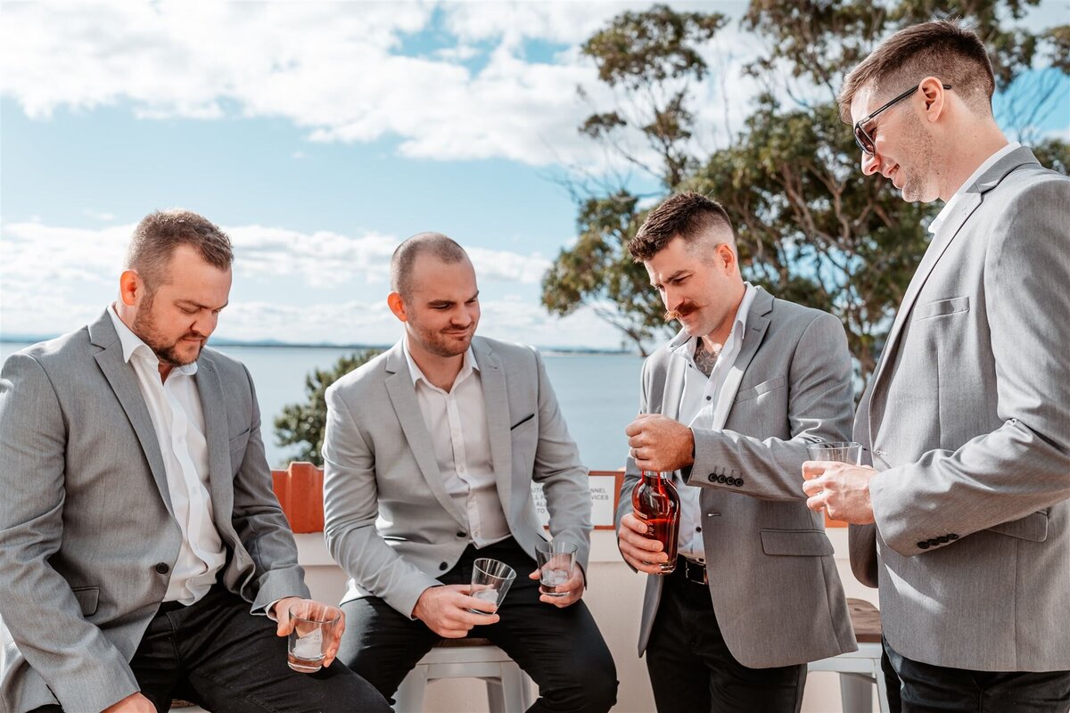 Cory together with his groomsmen are having fun and having a drink