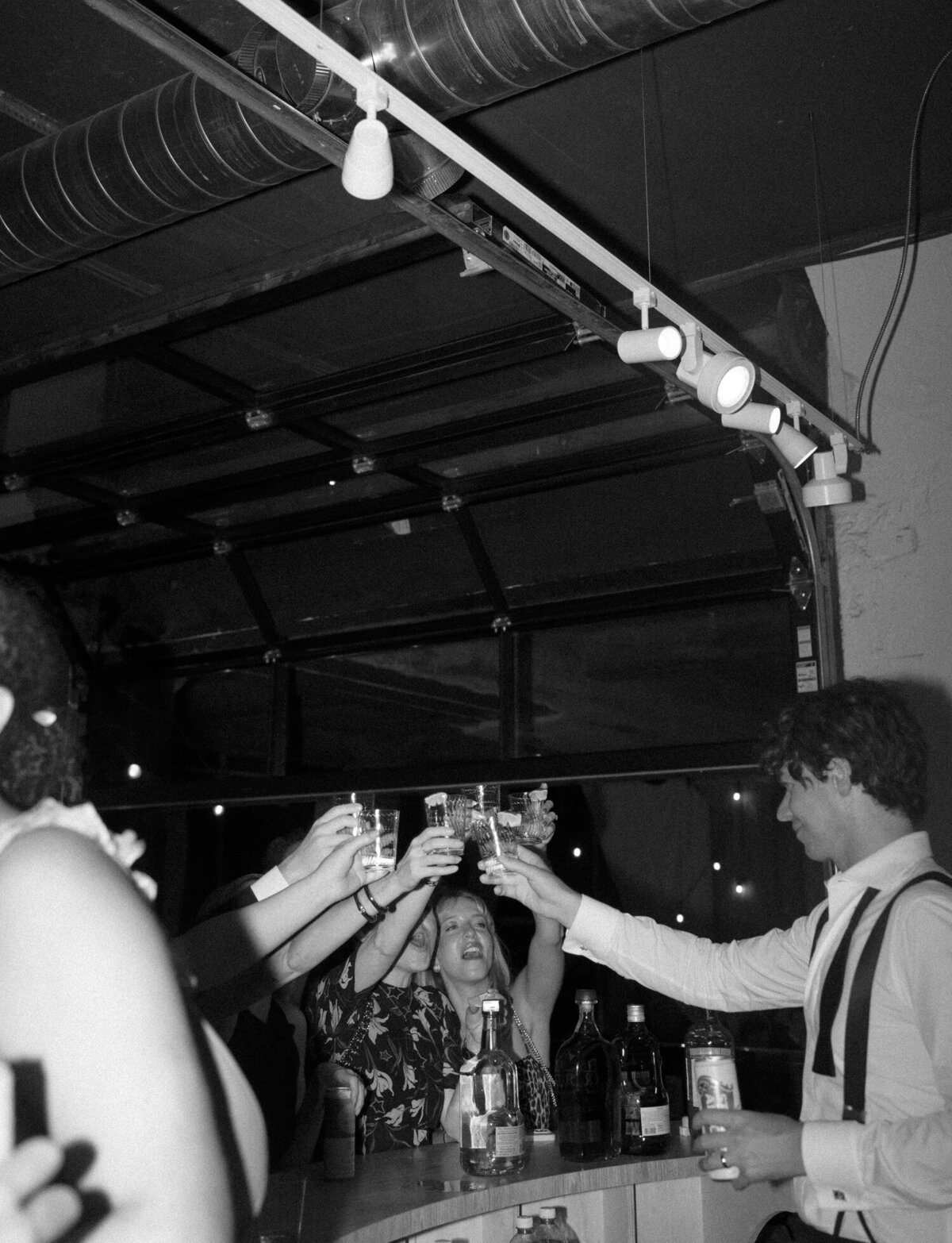 a groom bartends during his wedding after party in Detroit, Michigan