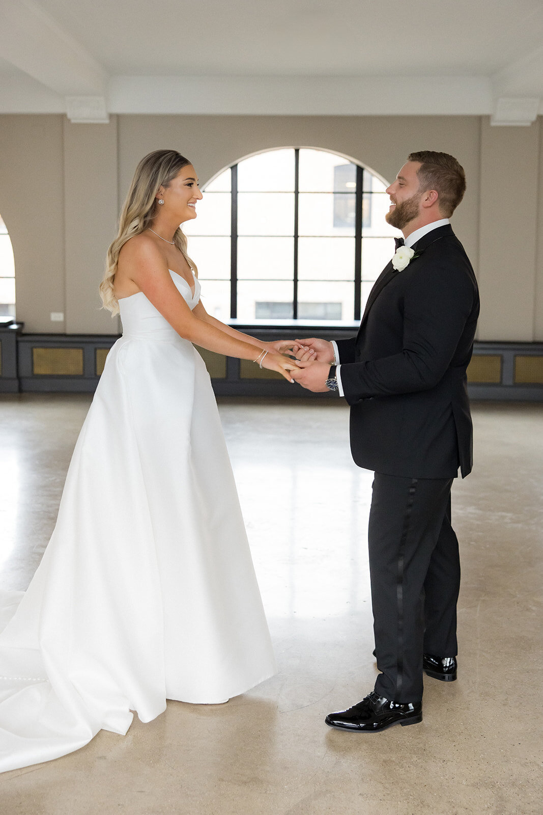 bride-groom-first-look-arched-window-revel-motor-row-HBICWeddings