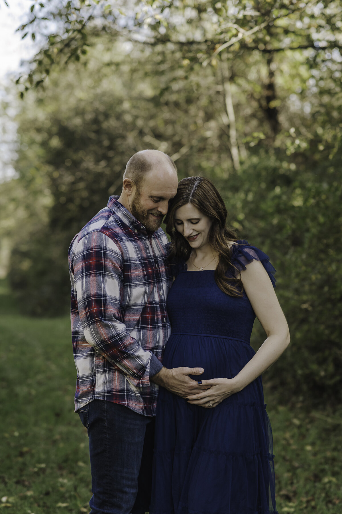 Verona B Photography captures a beautiful maternity picture of an expectant mom and her husband holding her belly at Silver Creek metro Park in Norton, OH. The couple’s love for each other and joy in anticipation of their baby was evident on their faces in this beautiful field setting near Akron, OH.