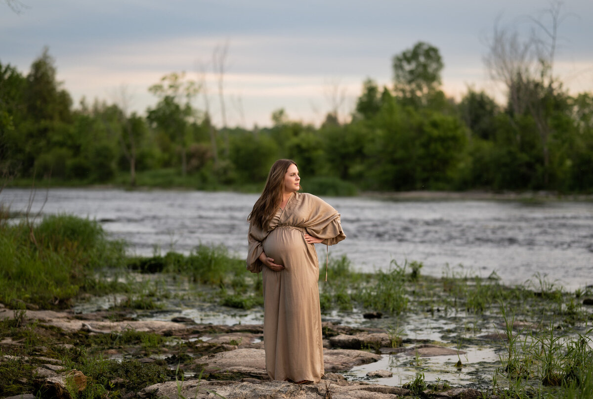Ottawa Mom looking at the Jock River in a Mrytle and Moss Maternity dress.