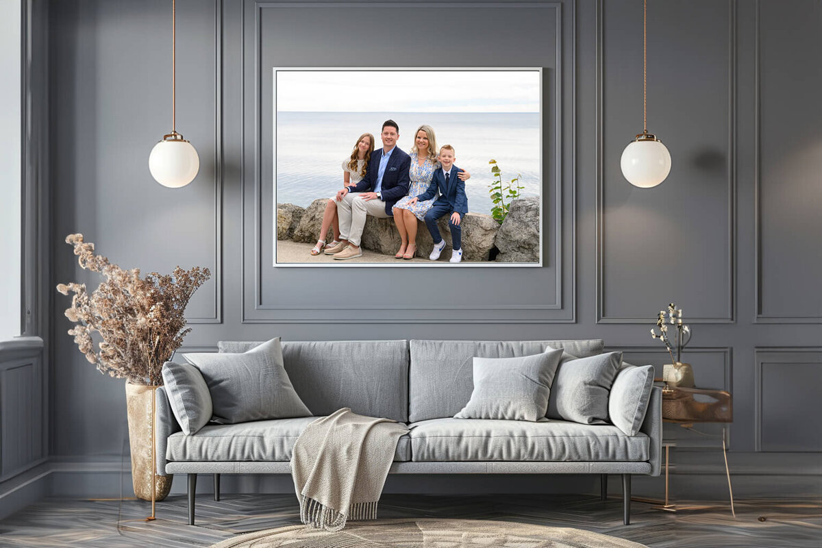 Grey living room with a framed photo of a family of four at the waterfront for their Burlington family photography session