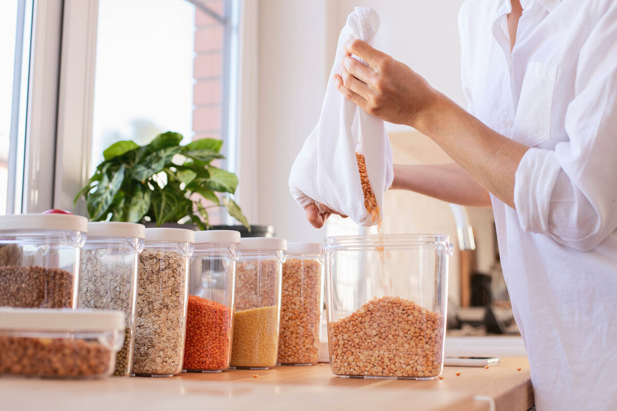 woman decanting kitchen staples