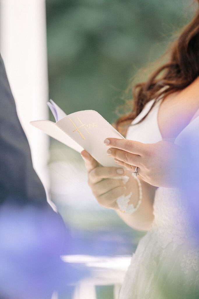 Bride reads from vow book during wedding ceremony, captured by Lorissa Lee Photography. Featured on Brontë Bride.