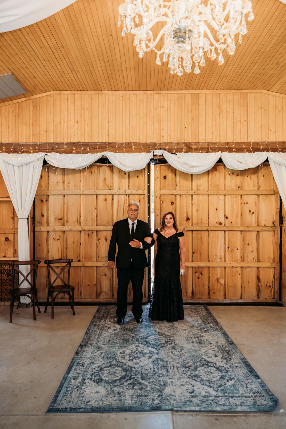 Parents walking down the aisle at the venue