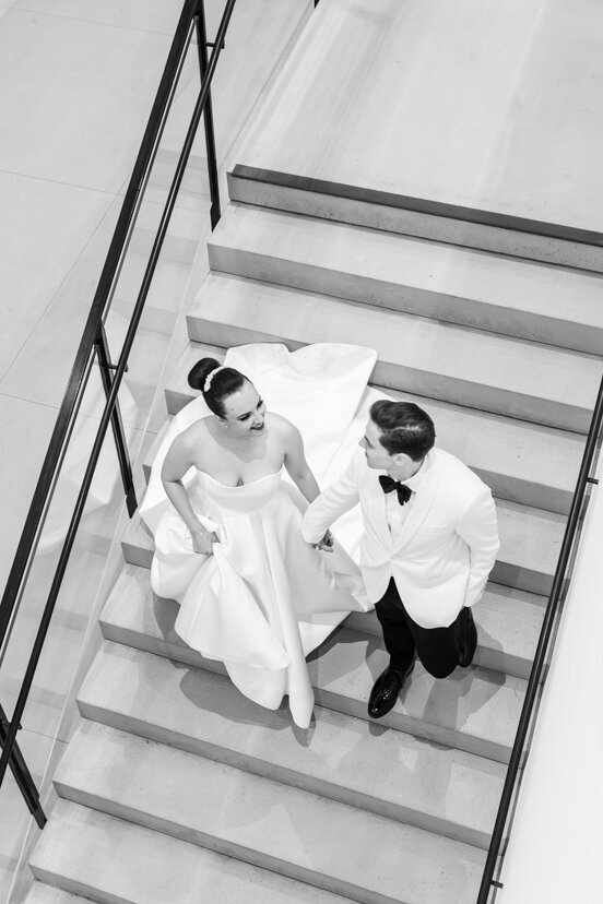 bride-and-groom-walking-down-stairs-at-museum-of-contemporary-arts-san-diego-wedding