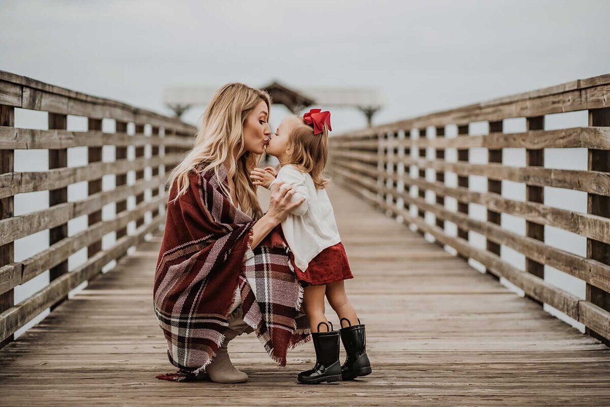 mom and daughter kissing