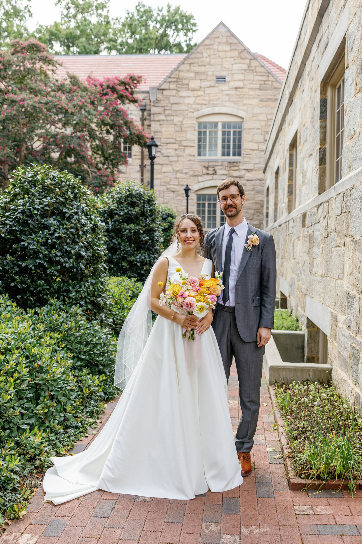 Just married couple standing in front of Market Hall facade, Raleigh wedding portrait