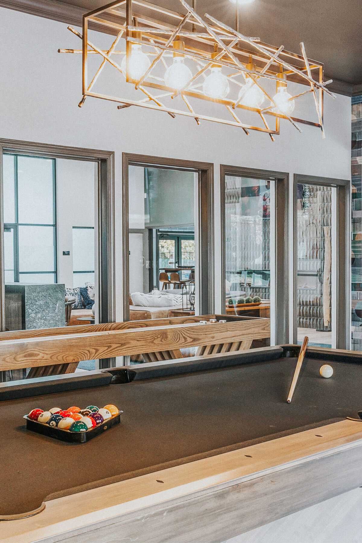 Game room at The Apex at Sky Valley in Reno with a pool table, modern decor, and lounge seating.