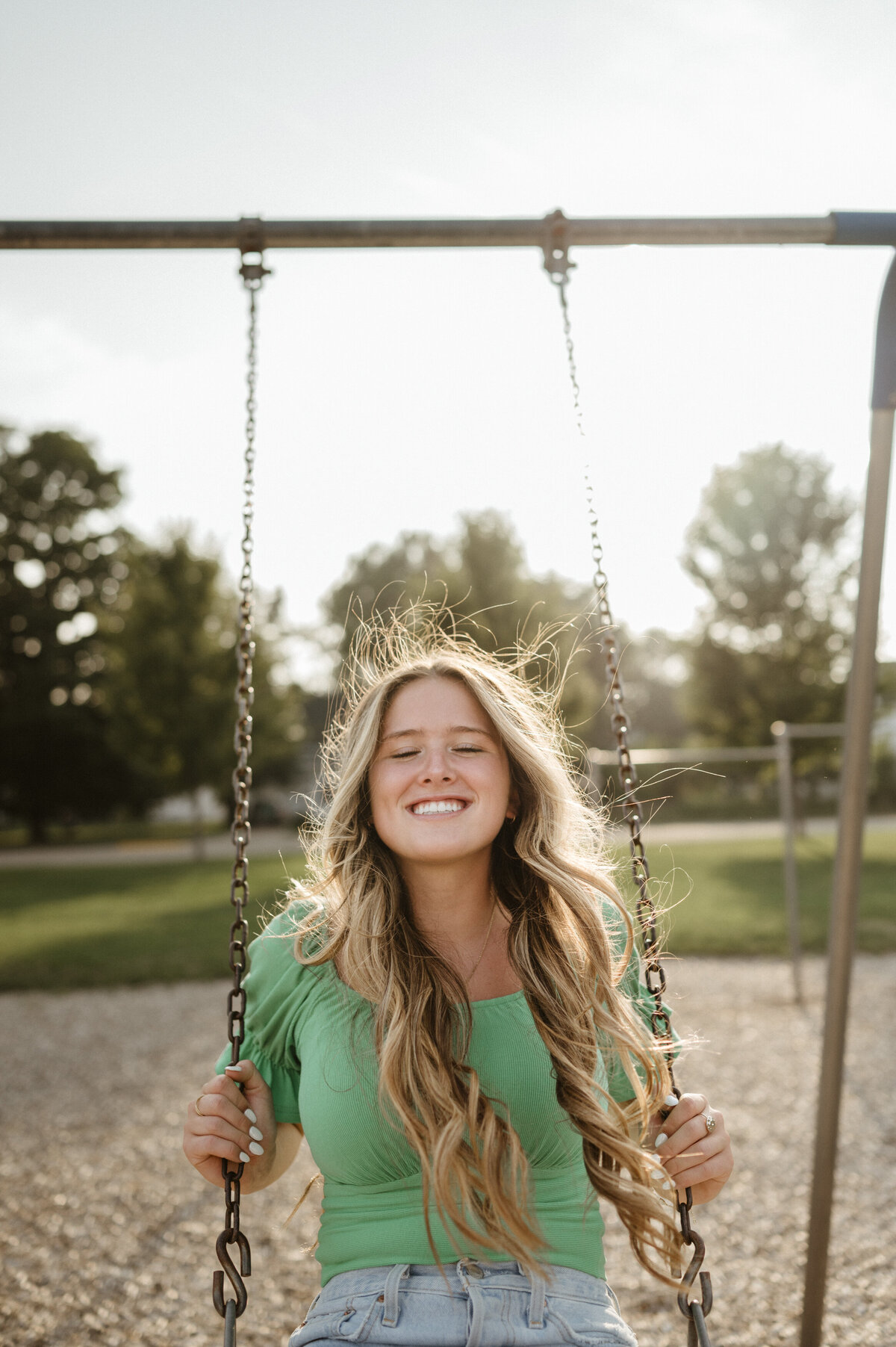 Girl in green shirt on a swing