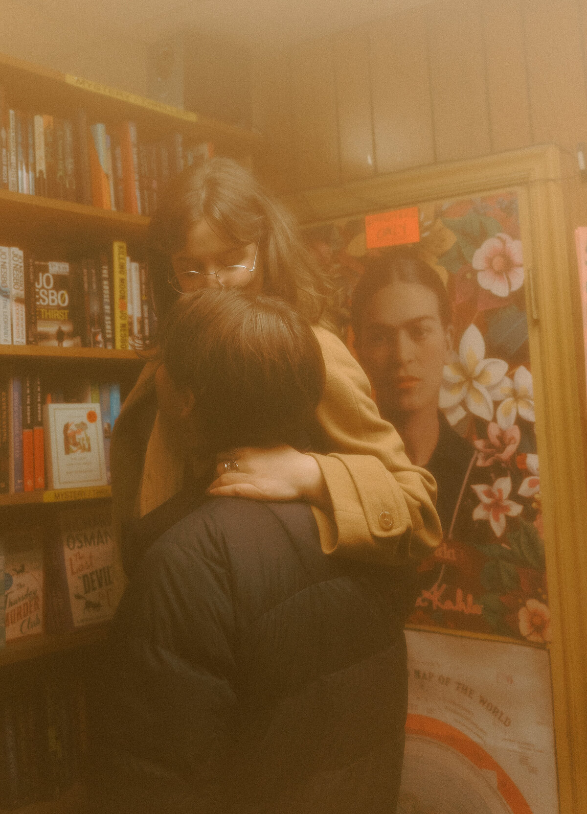 couple embracing in bookstore, super 8 photography