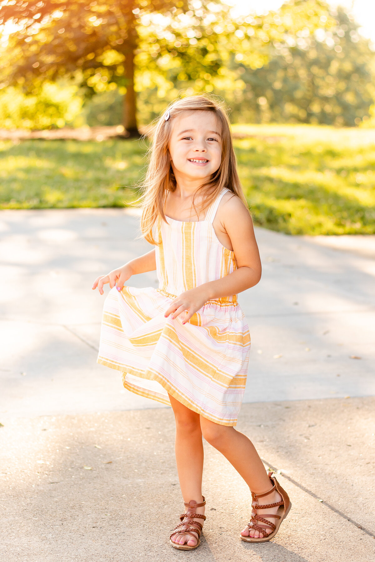 Little girl twirling her dress in the sunshine