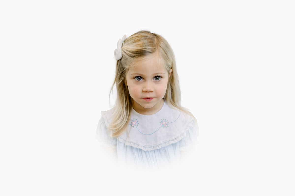 Young girl in blue and white heirloom dress photographed in a southern heirloom style