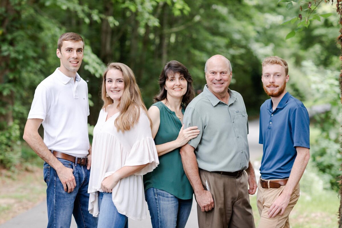 A family of five with older children posing for their family portrait.