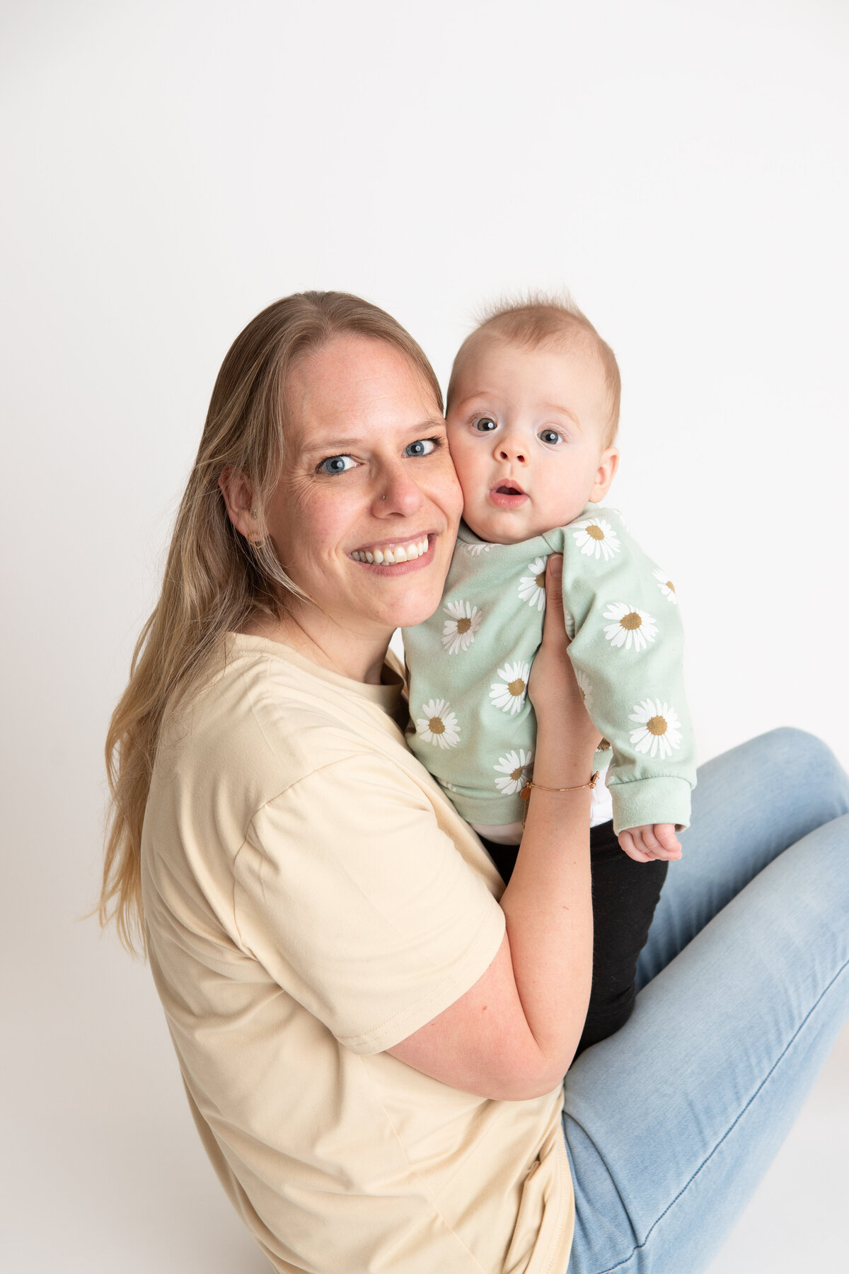 Mom and daughter on a simple white savage backdrop