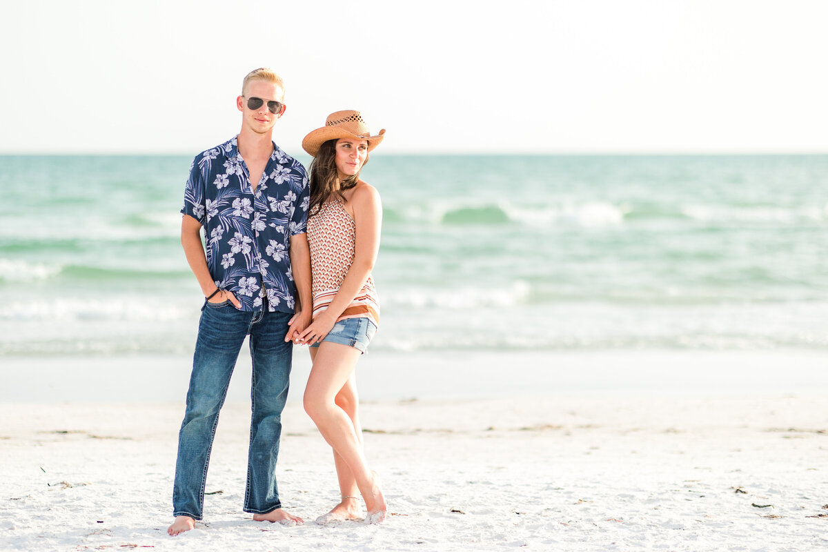 A young couple pose in front of Florida's Gulf Coast on a Sarasota Beach