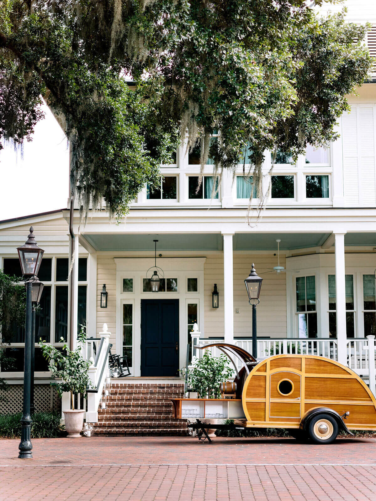 A cute wooden cart with wheels in front of a pretty house in Montage at Palmetto Bluff. Destination wedding image by Jenny Fu Studio