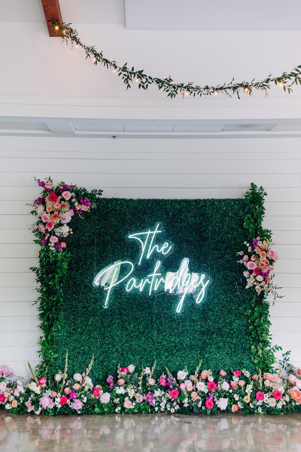 photo wall with floral installation at wedding reception the annex wny