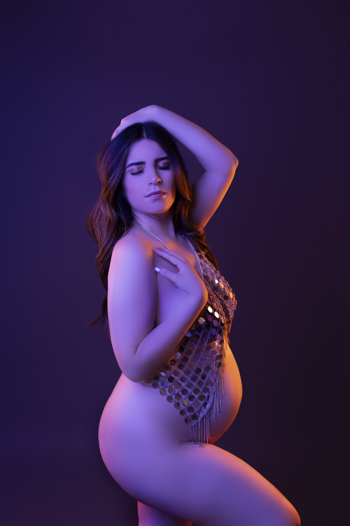 woman in purple gel lighting for phoenix maternity session