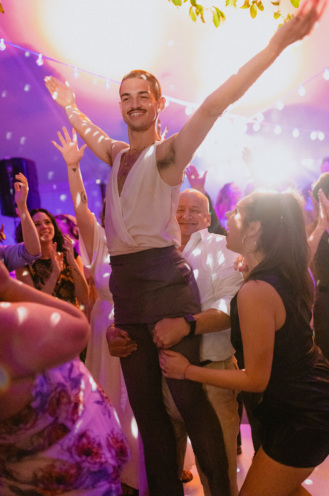groom-held-up-by-guests-disco-dancing