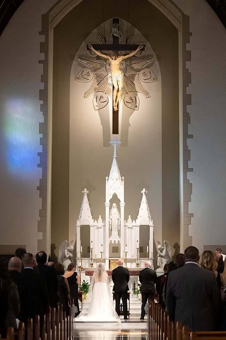 Bride and Groom photographed from behind  standing at altar at First Presbyterian Church in Beaver, PA