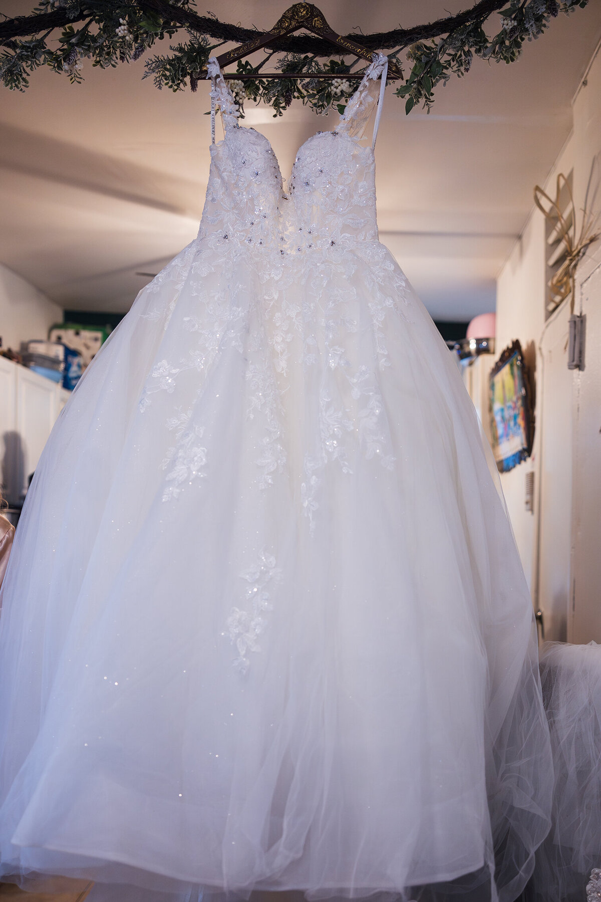 Dress hanging in Bride's home.