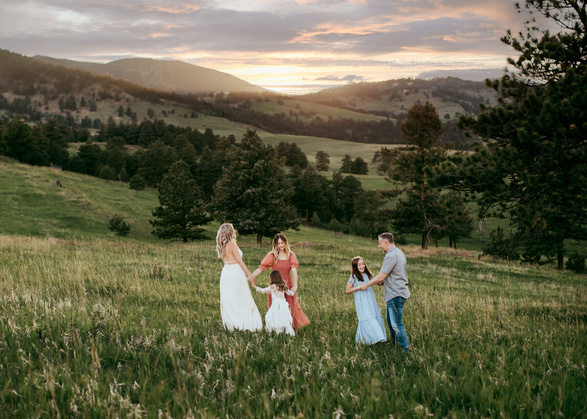 family pf 5 in a field at sunset in Golden Colorado for family photography session with Erin Jachimiak Photography