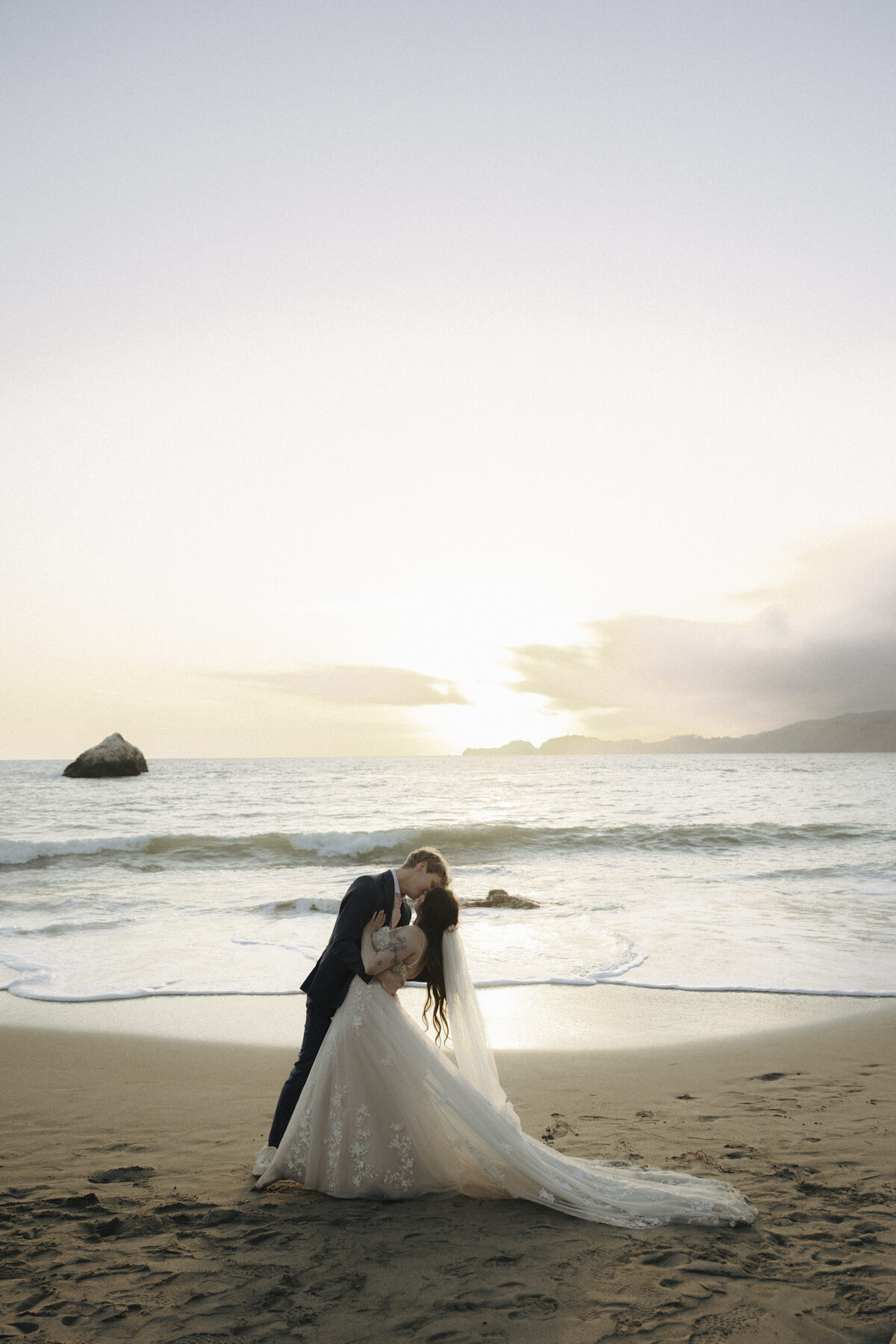 Bride and Groom at Marshall's Beach in San Francisco, California at sunset