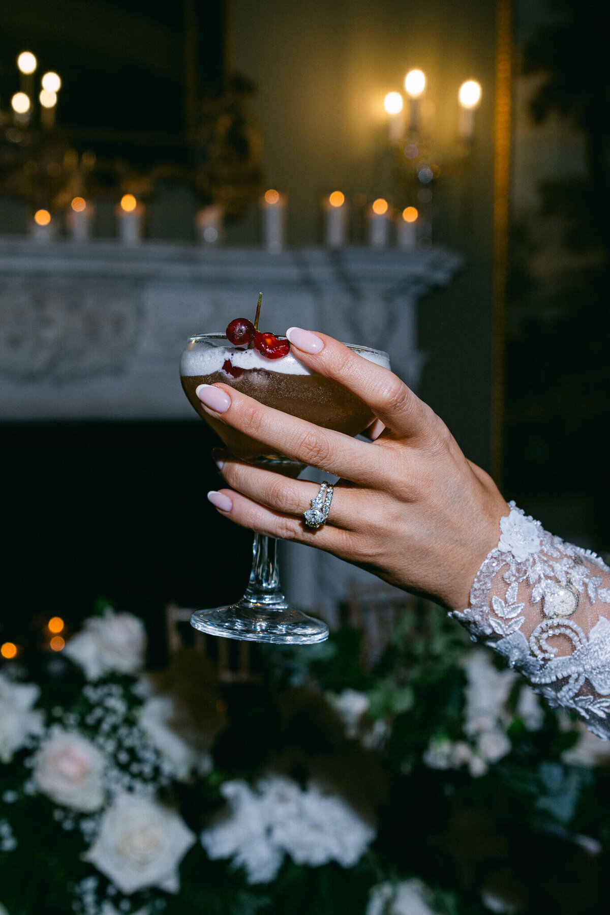 A photo of a bride holding her signature cocktail during cocktail hour during her wedding day at Luttrellstown Castle in Dublin Ireland