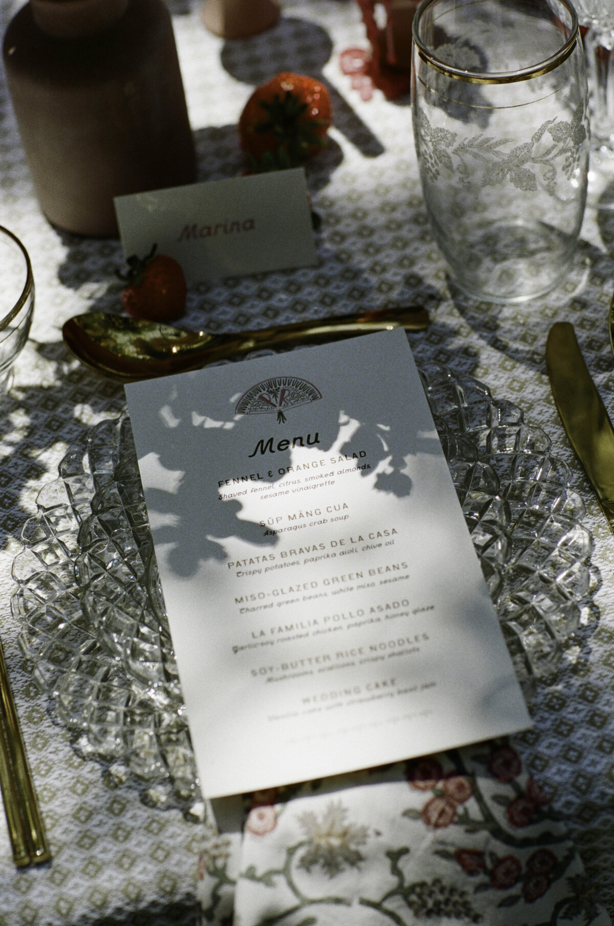 Garden party outdoor reception table with illustrated menus and strawberries with wedding florals by Good Seed Floral photographed by Taylor Friedman Photo