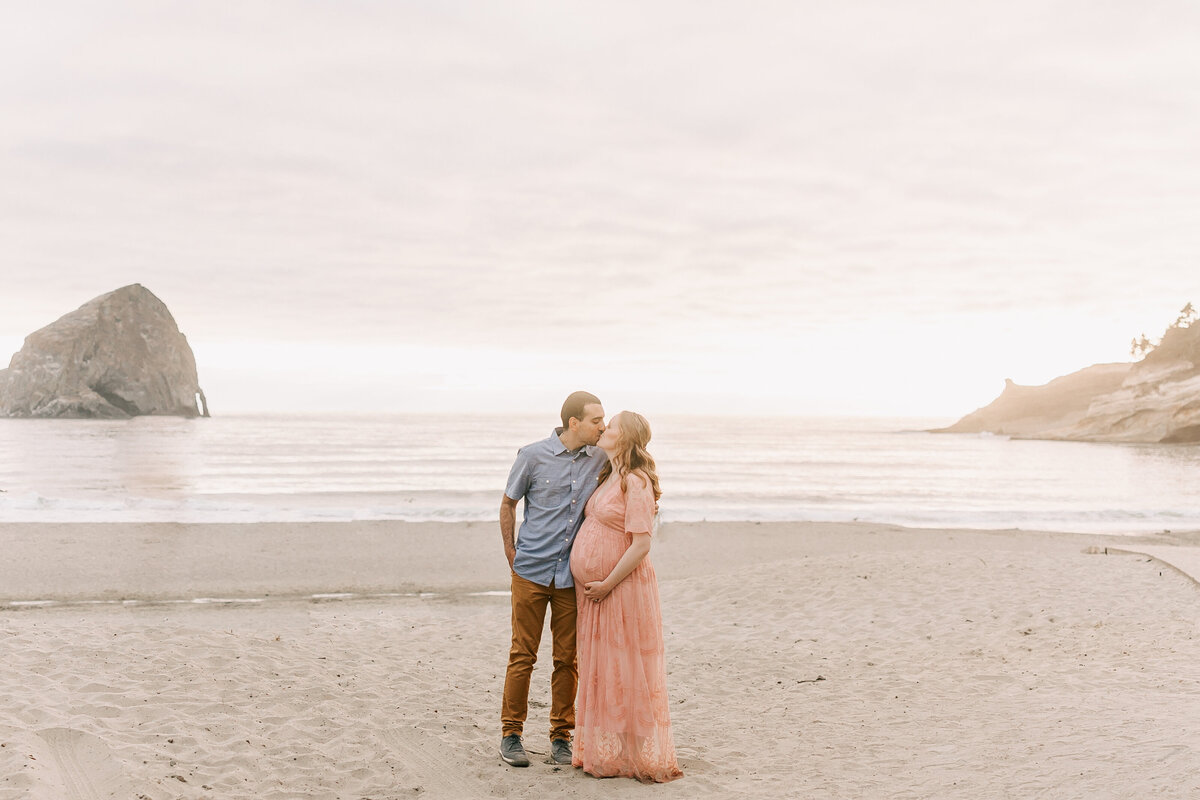Stunning portrait of a couple on an oregon beach for their maternity session.