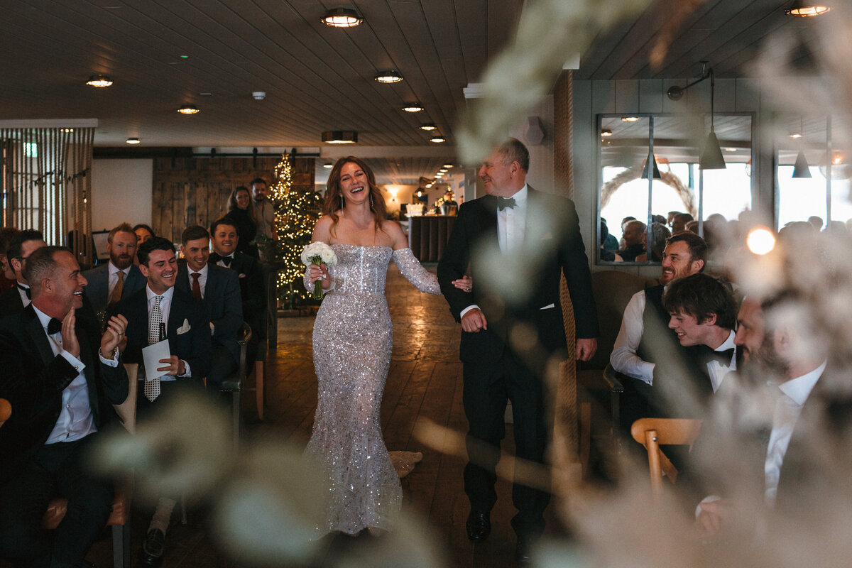 Bride walsk up aisle with Dad at Gara Rock wedding