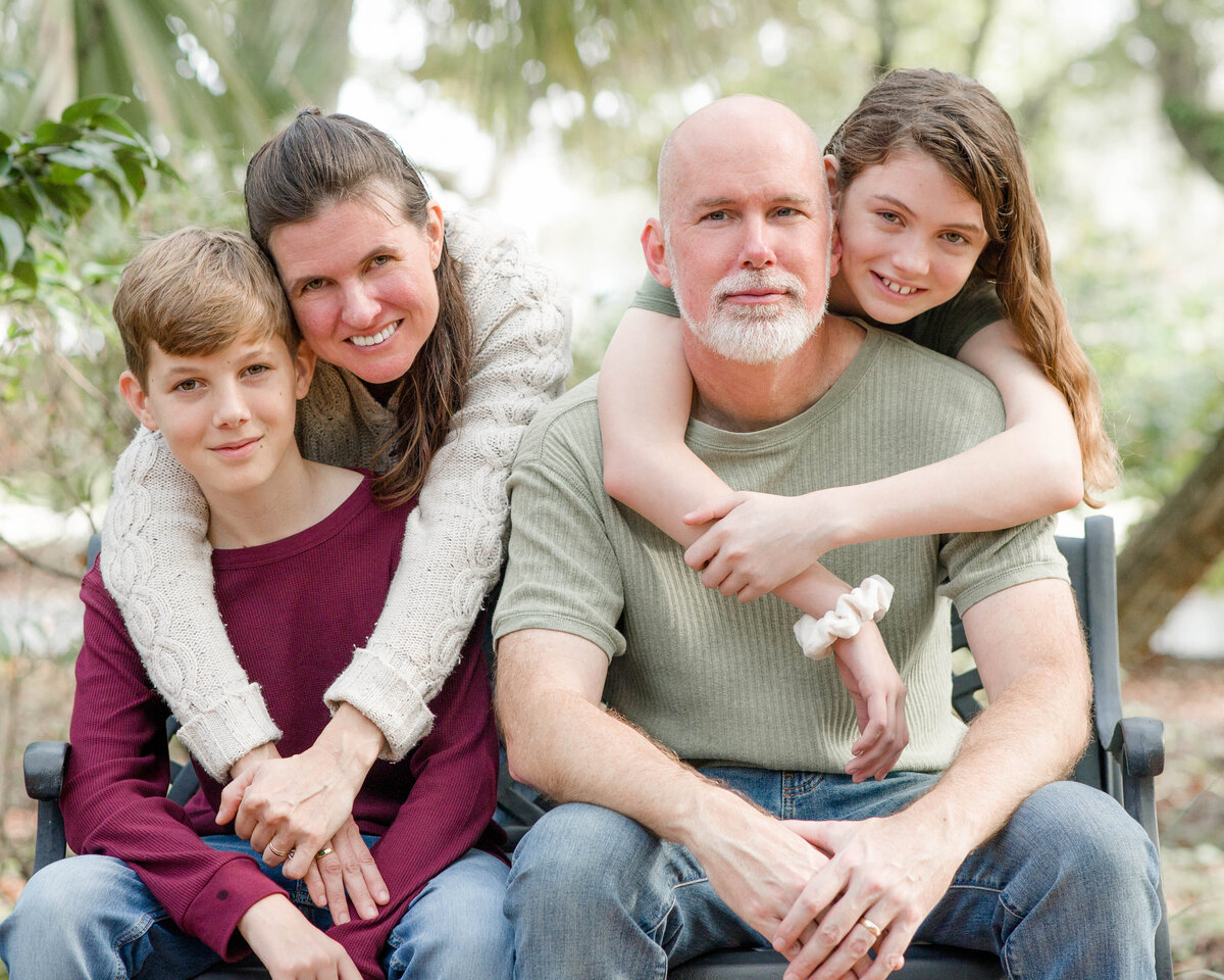 family portrait sitting on benchby Lucas Mason Photography in Orlando, Windermere, Winder Garden area