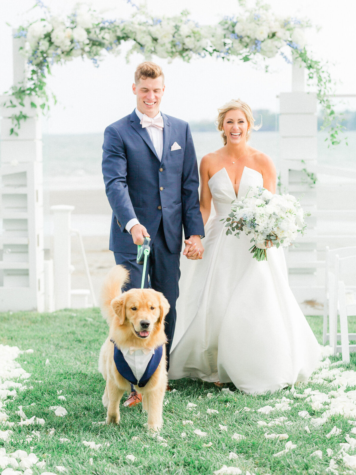 bride and groom walking their dog at newport beach house RI