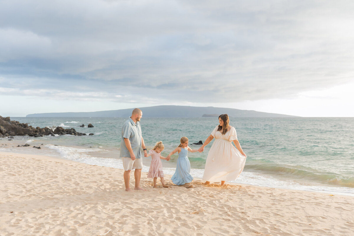 Photo taken by Maui family photographer, Karma Hill Photography of family walking on the beach in the sand
