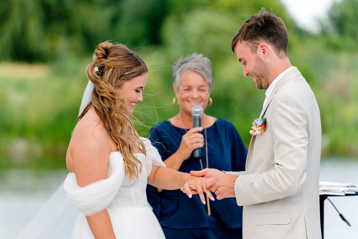 groom-places-ring-on-brides-finger