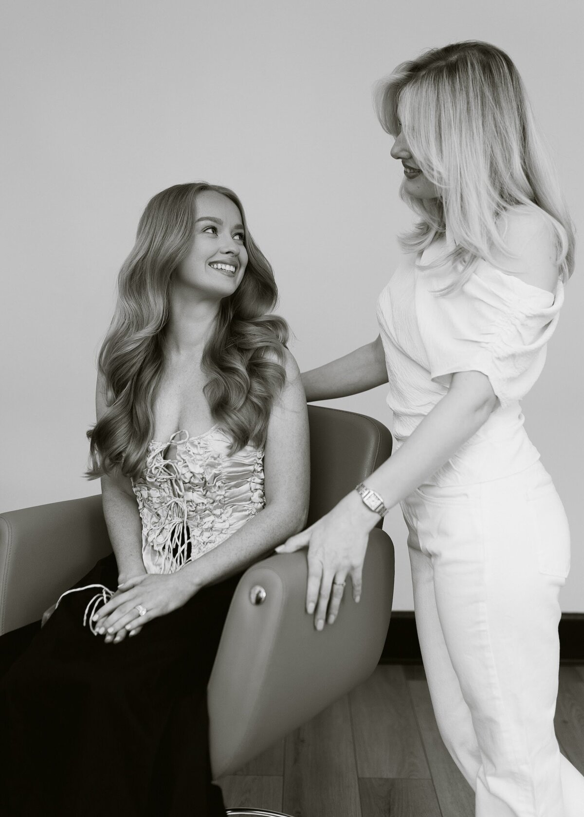 Yana interacting with a client during a brand shoot, showcasing her warm and supportive energy in the bridal prep process.