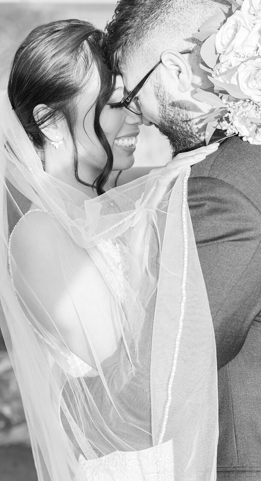 bride and groom with veil