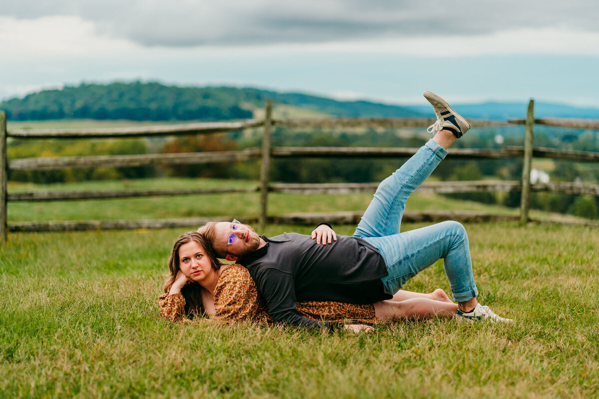 Couple goofing off and laughing in a grassy field