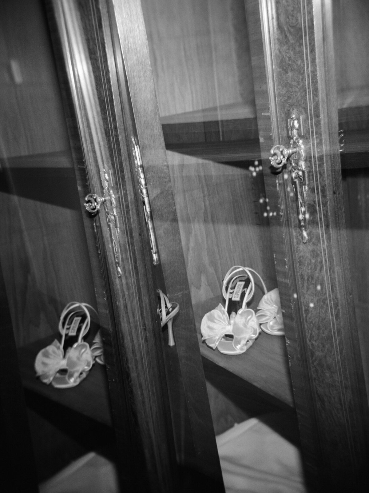 a holga film double exposure film photo of badgley mischka wedding shoes in an ornate wardrobe in Detroit, Michigan