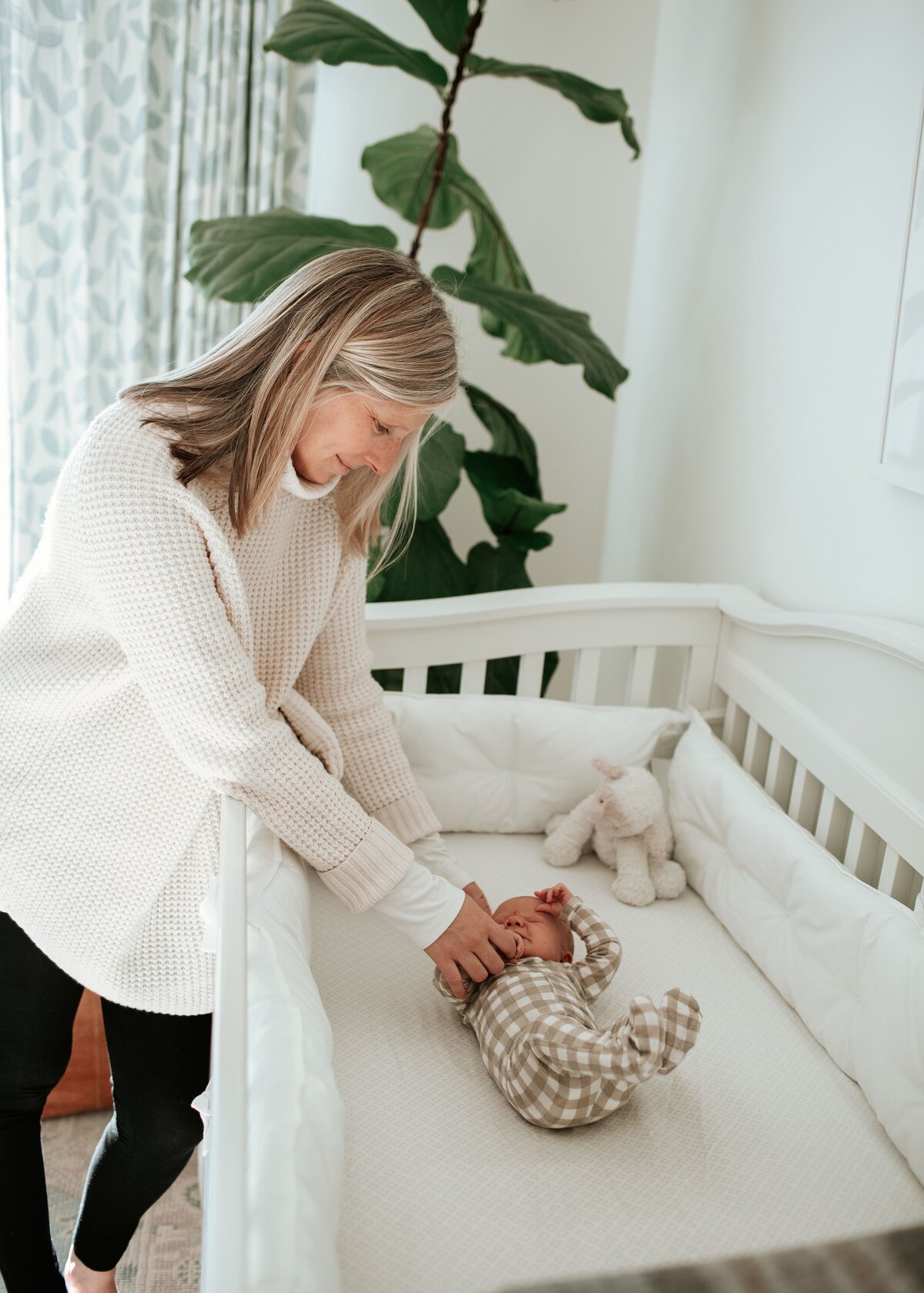 mom soothing her baby to sleep during their home baby photos