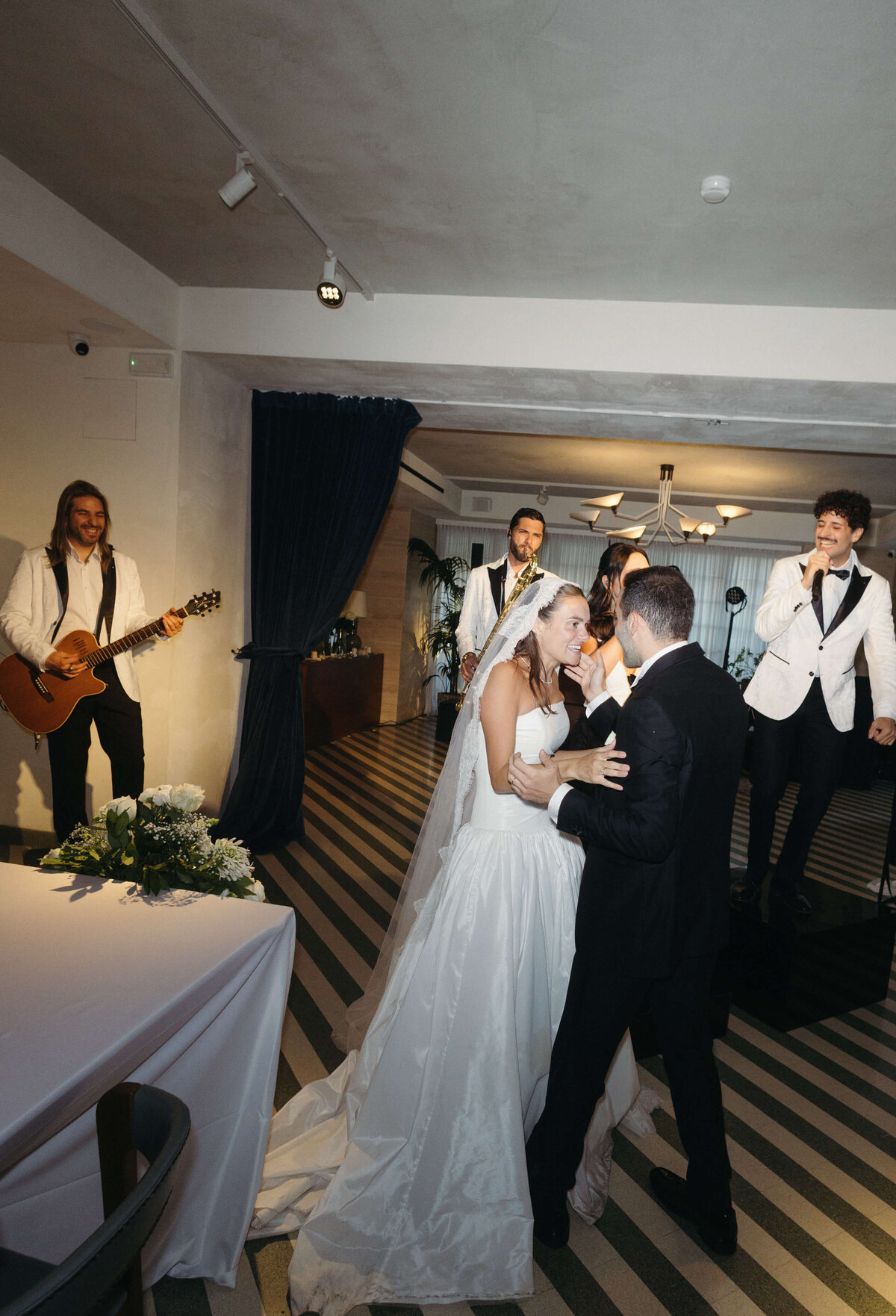 Wedding guests dancing and cheering at lively Soho House Rome reception

