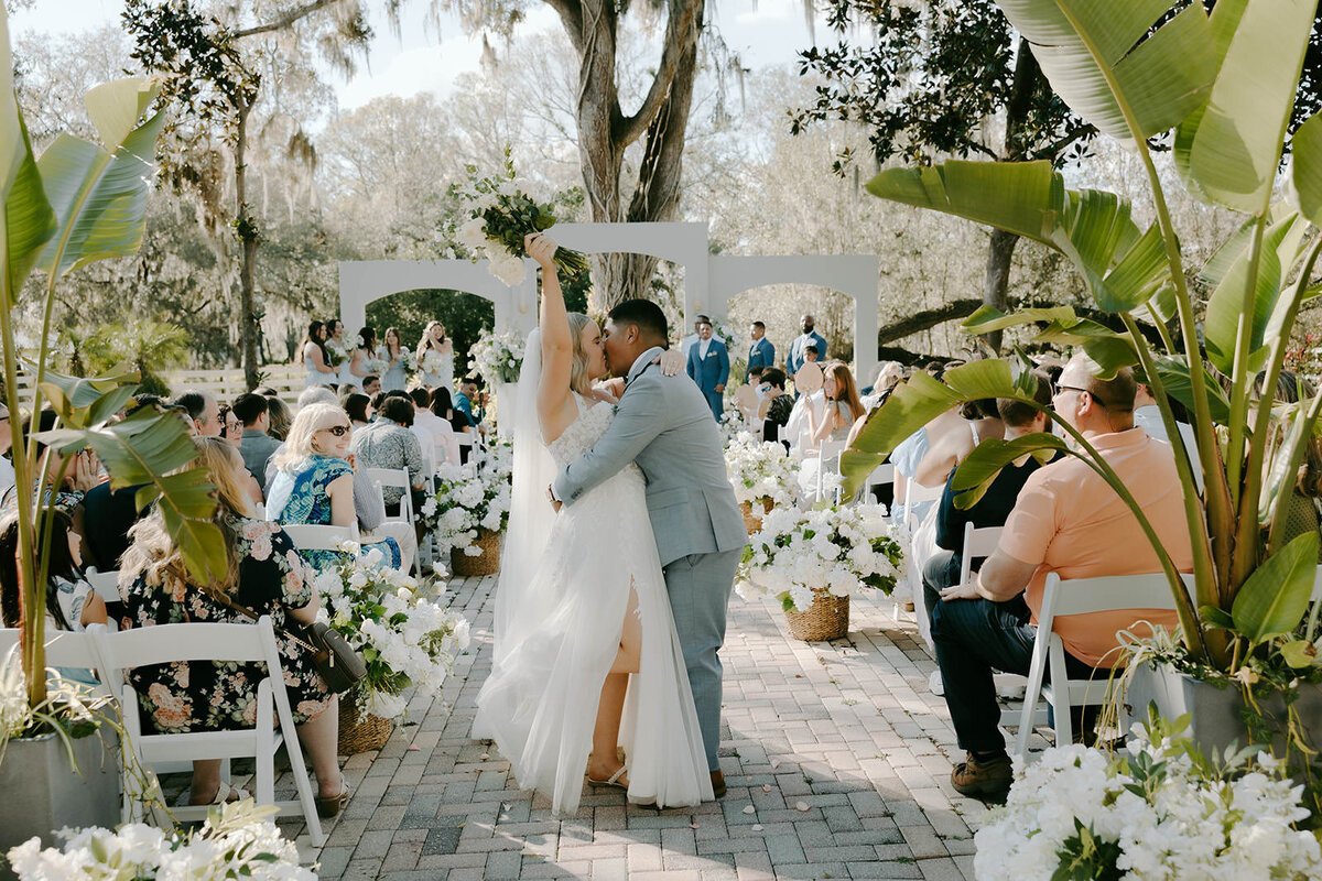 Bride walking past wedding guests at Uliana Estate in Lakeland Florida.