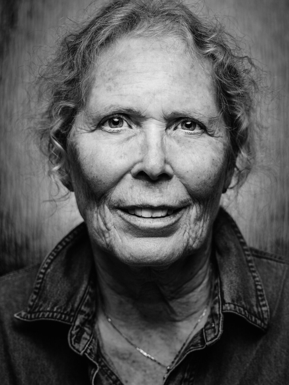 Black and white photo of an older woman smiling