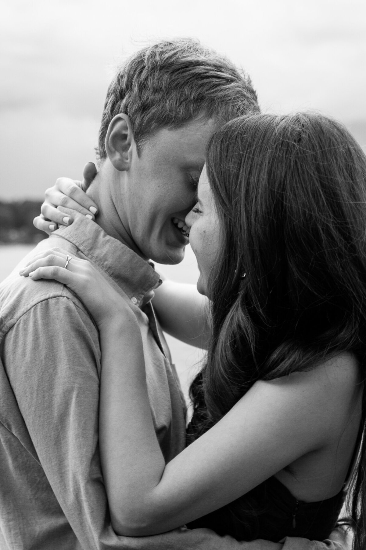 Engaged couple goes in to share a kiss.