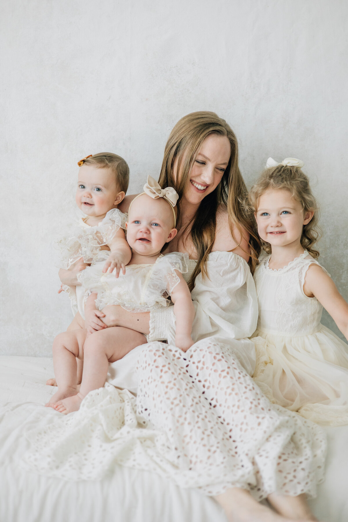 Motherhood image taken in studio with three daughters taken in Lewisville, TX